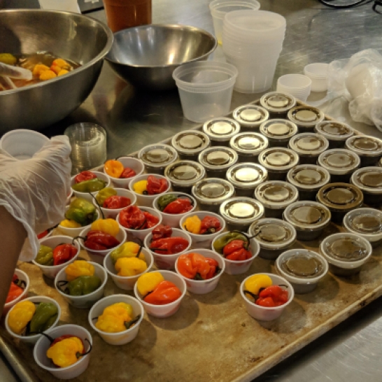 Scotch bonnets being portioned out for takeout